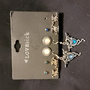 6 pairs of earrings, 1 blue earring missing.